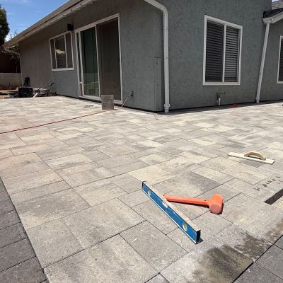 Paver patio being installed beside a home, San Marcos