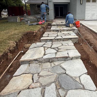 Flagstone walkway being set beside a driveway, San Marcos
