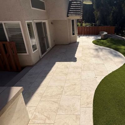 Curved concrete patio meeting artificial turf, Carlsbad