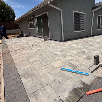 Paver patio with a contrasting border along the side of a home, San Marcos
