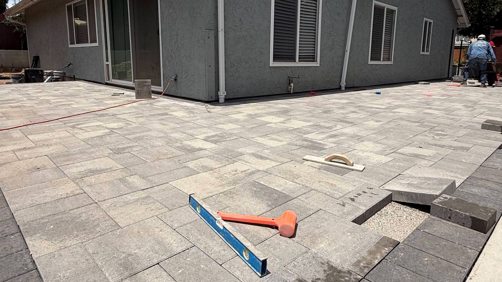 Paver patio being installed along the side of a home, San Marcos