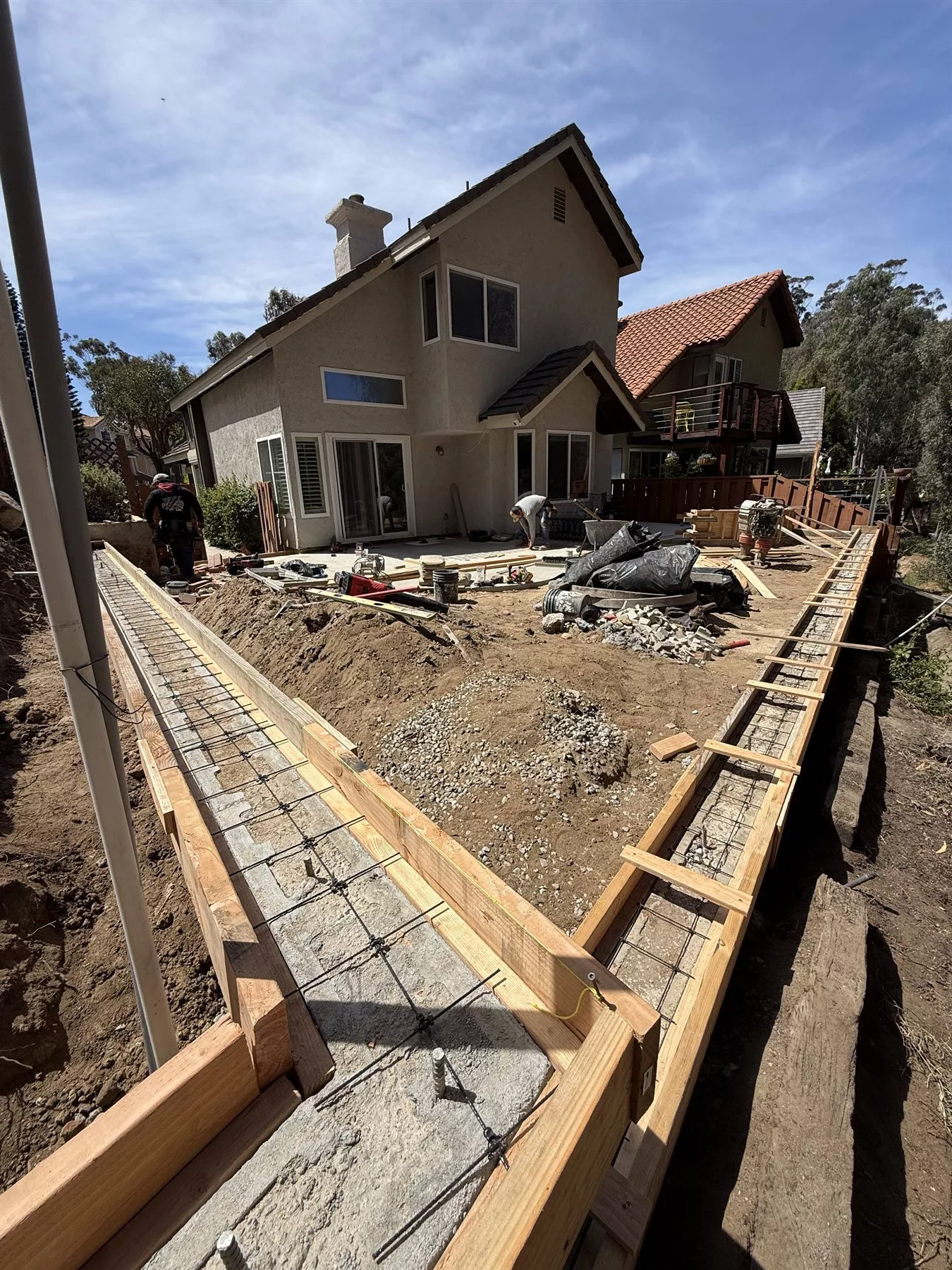 Reinforcement and formed structural concrete during a sloped backyard rebuild in Carlsbad, CA