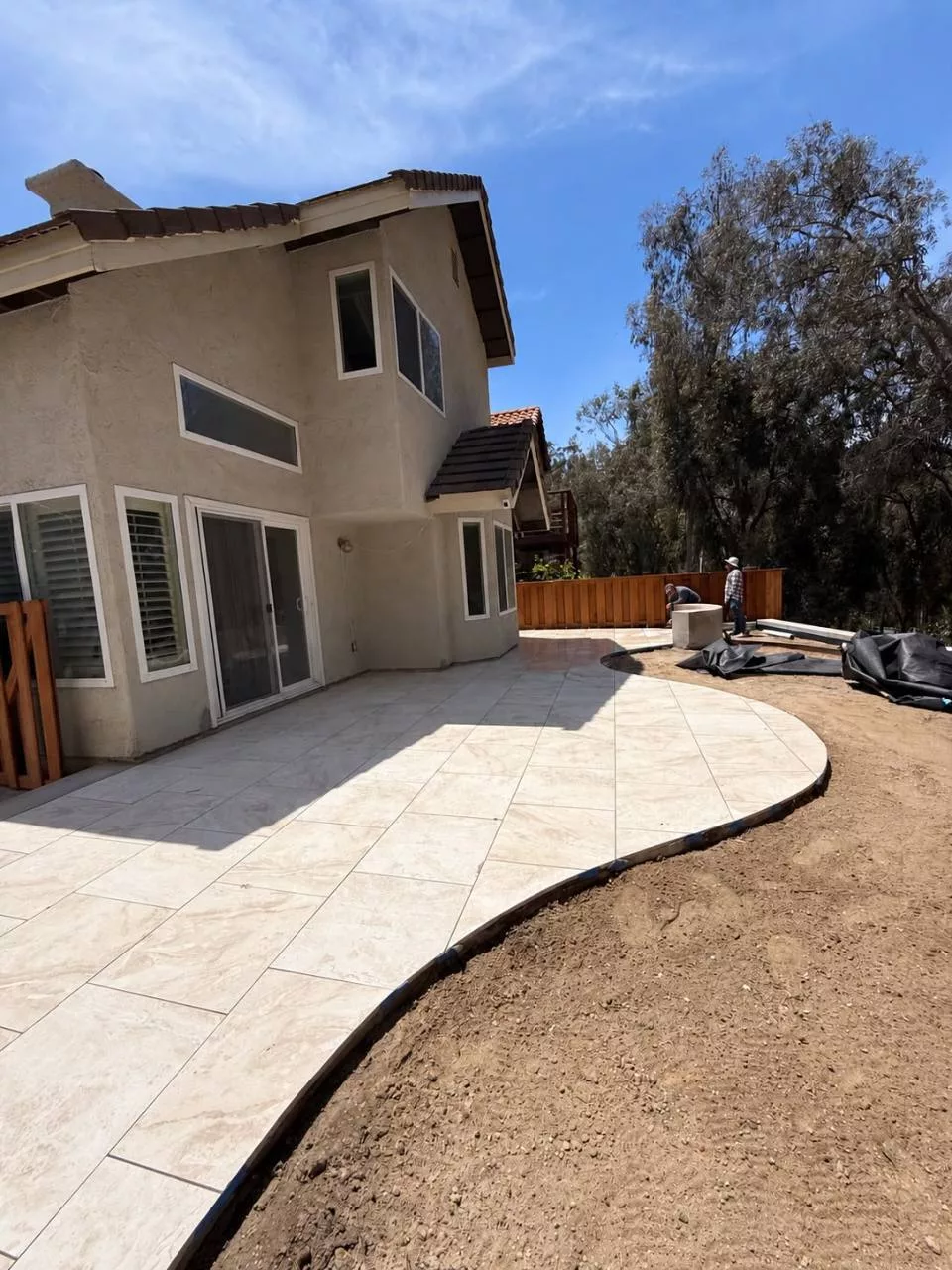 Large-format porcelain paver installation beside a Carlsbad home