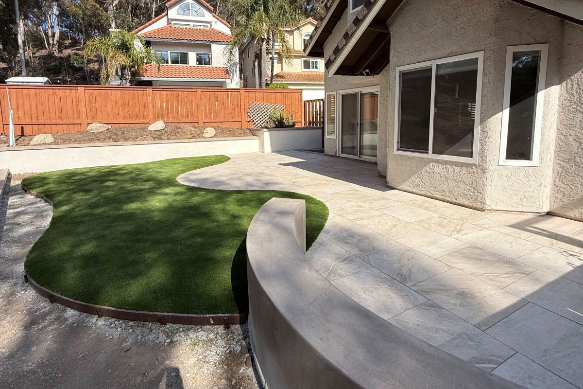 Artificial turf lawn with a curved edge and concrete border, Carlsbad