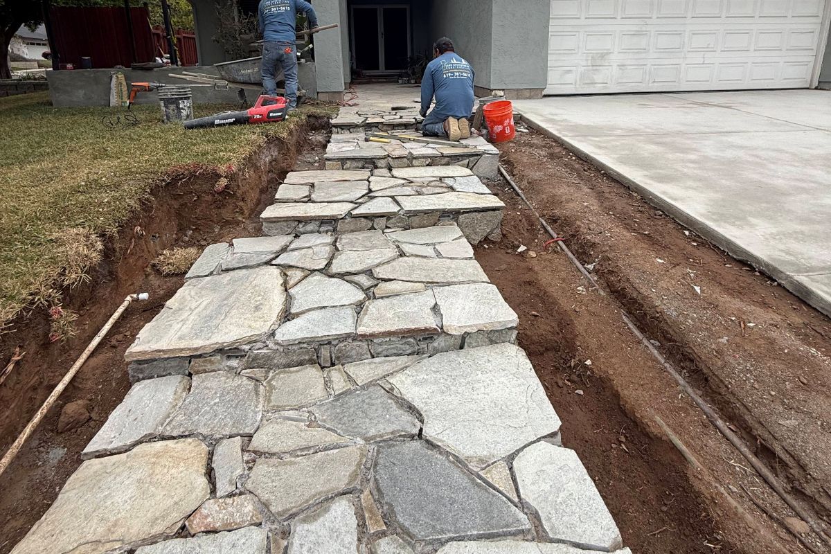 Flagstone walkway being set beside a driveway, San Marcos