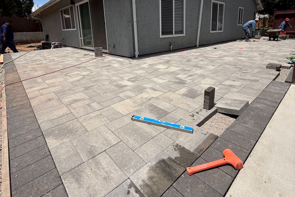 Paver patio with a dark border beside a home, San Marcos